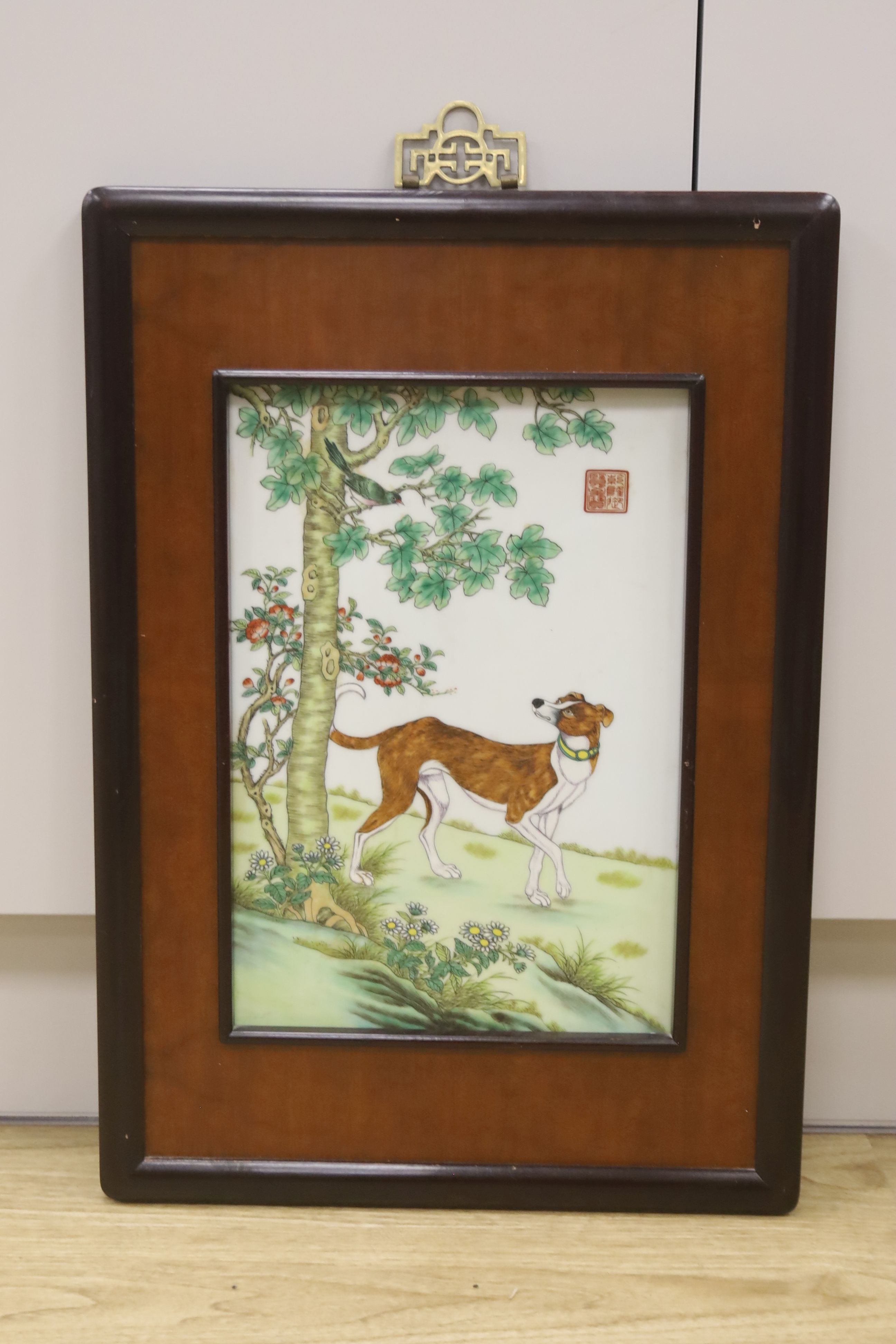 A Chinese porcelain plaque of a dog after Castiglione, 36 x 24cm, framed